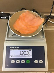 sliced salmon being weighed